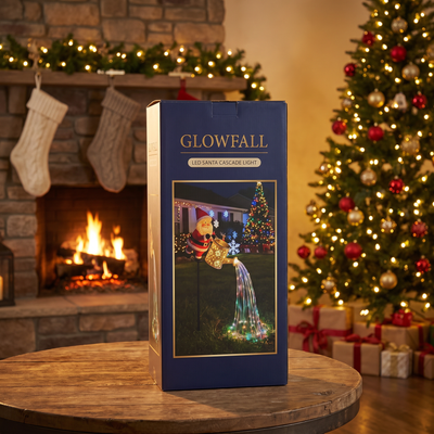 GLOWFALL Santa Cascade Light box on a table by the fireplace and Christmas tree